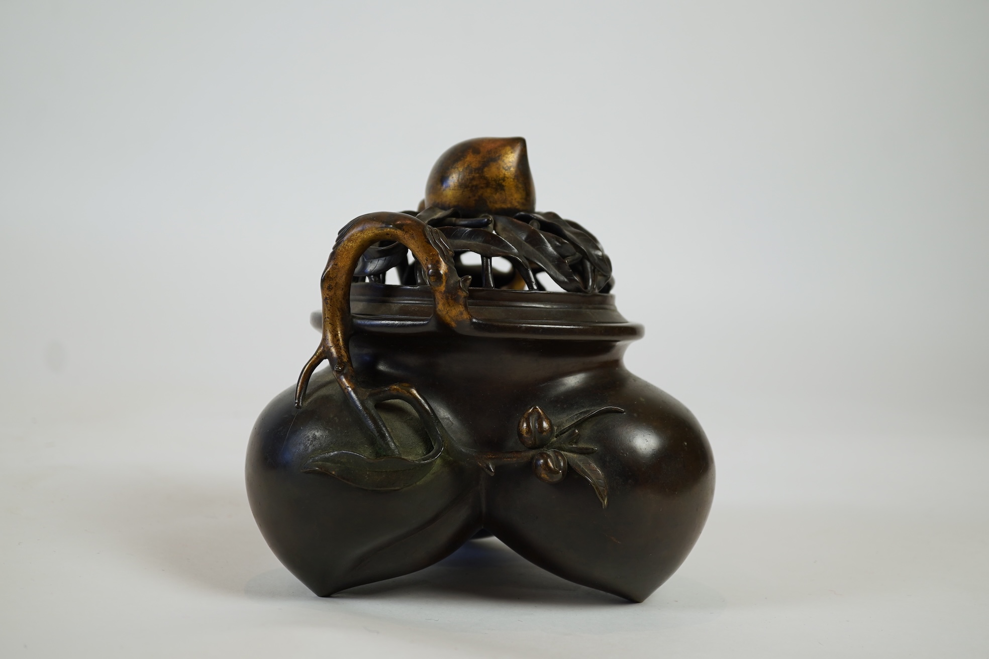 A large Chinese bronze and parcel gilt ‘peach’ censer and cover, Li, 17th/18th century